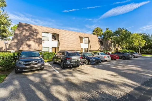 a view of a cars park in front of a house