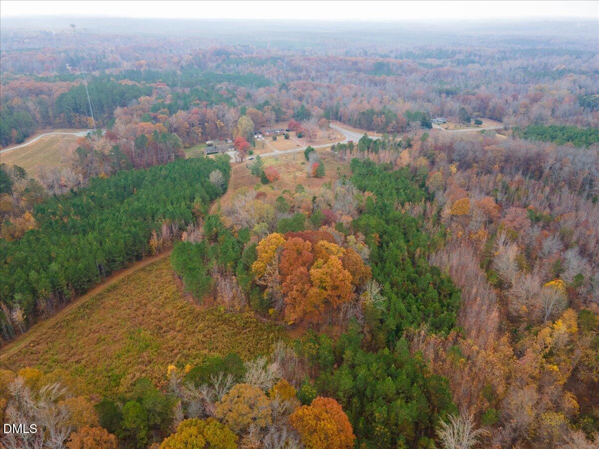 1923 Lawson Chapel Church Road Roxboro, NC 27574 - Photo 8 of 19 an aerial view of a house with a yard and mountain view in back