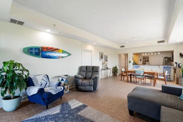 a living room with furniture and a potted plant