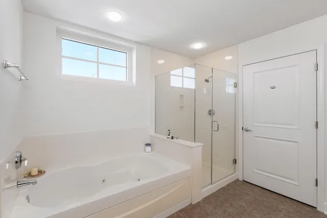 a bathroom with a bathtub and a shower
