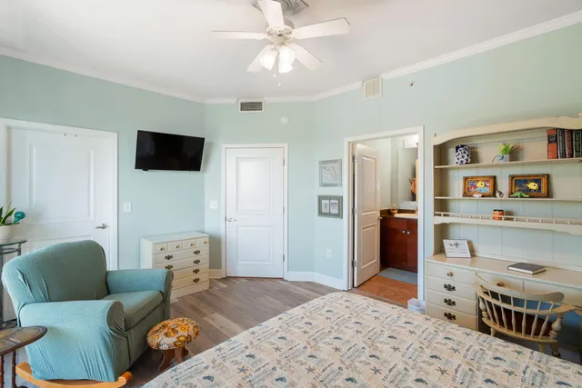 a bedroom with furniture and a flat screen tv