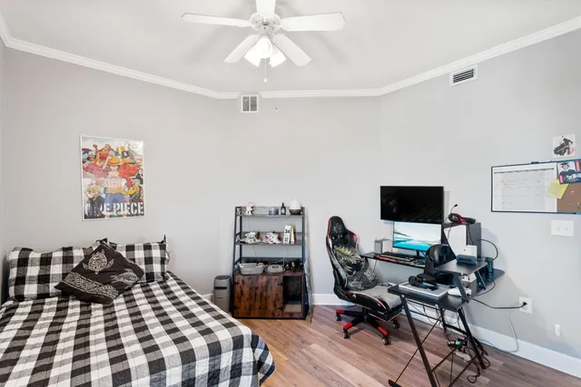 a bedroom with a bed and a desk