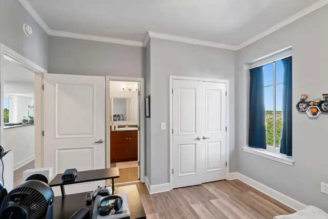 a view of a workspace with furniture and windows