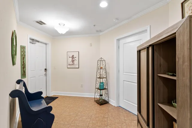 a view of a livingroom with entryway and furniture