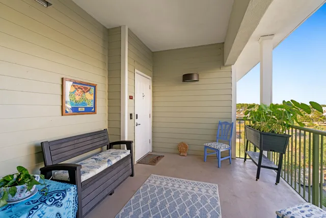 a view of a terrace with furniture and wooden floor