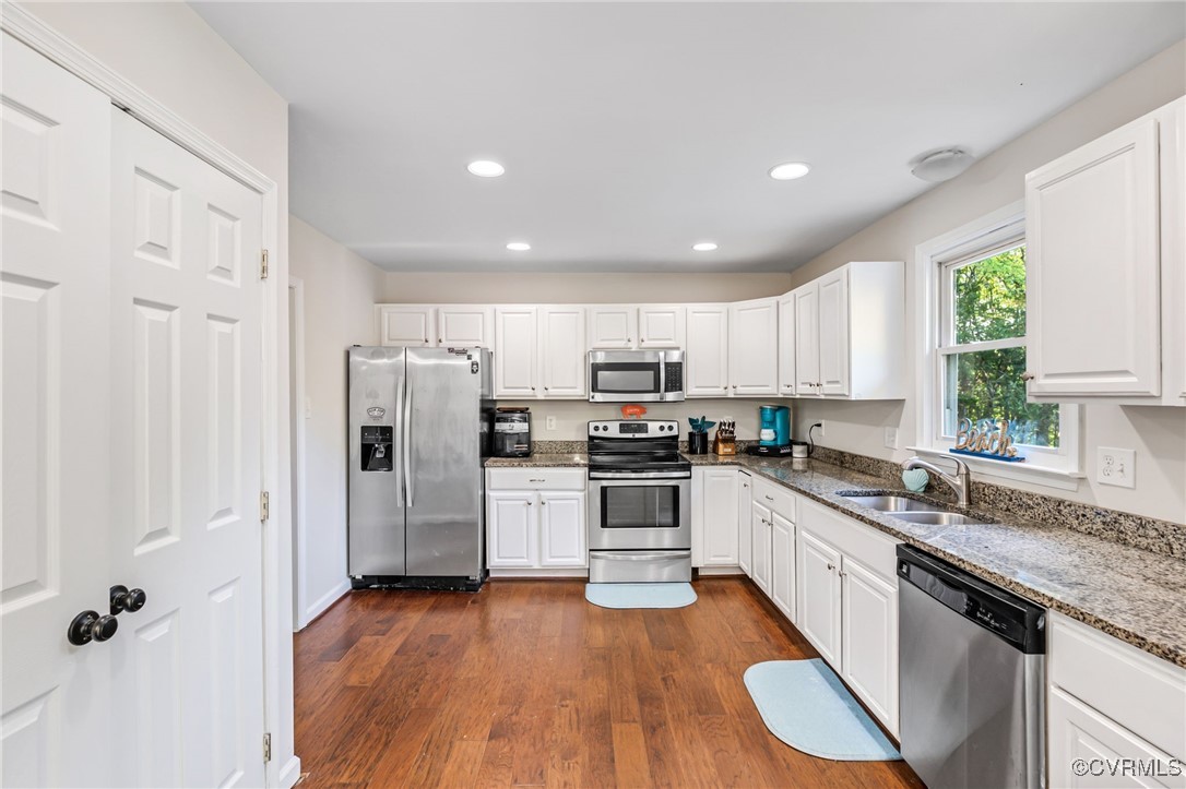 11925 Belfonte Road Bumpass, VA 23024 - Photo 11 of 34 a kitchen with white cabinets and white appliances