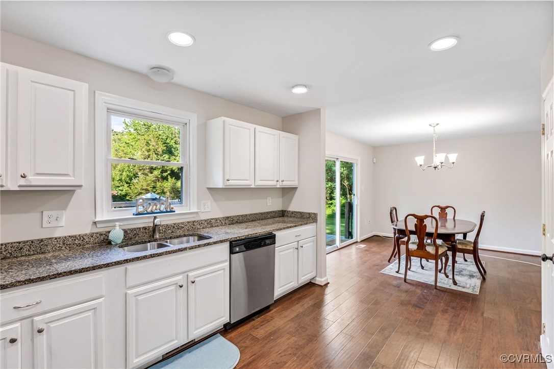 11925 Belfonte Road Bumpass, VA 23024 - Photo 13 of 34 a kitchen with stainless steel appliances granite countertop wooden floor a dining table chairs and granite counter tops