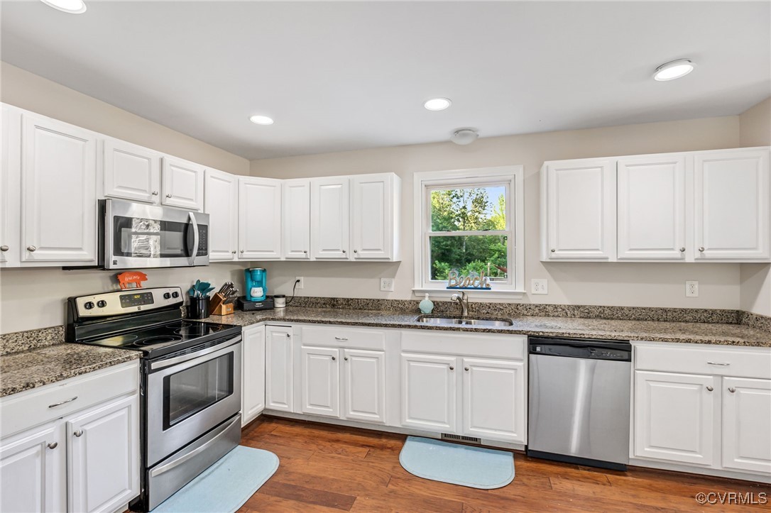 11925 Belfonte Road Bumpass, VA 23024 - Photo 14 of 34 a kitchen with granite countertop white cabinets and white appliances