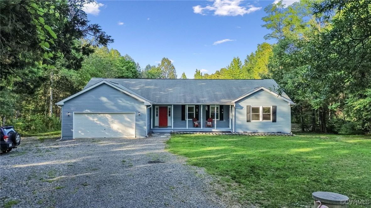 11925 Belfonte Road Bumpass, VA 23024 - Photo 2 of 34 a front view of a house with a yard and garage