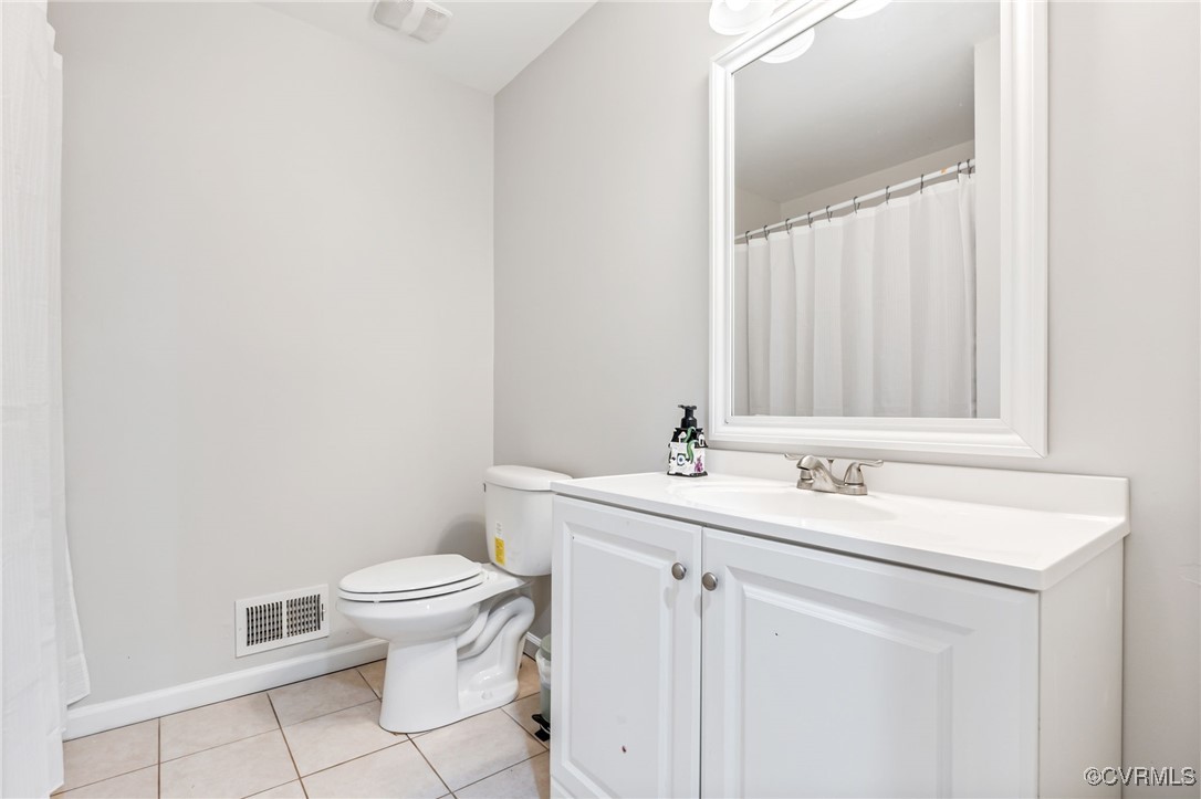 11925 Belfonte Road Bumpass, VA 23024 - Photo 26 of 34 a bathroom with a toilet sink and mirror