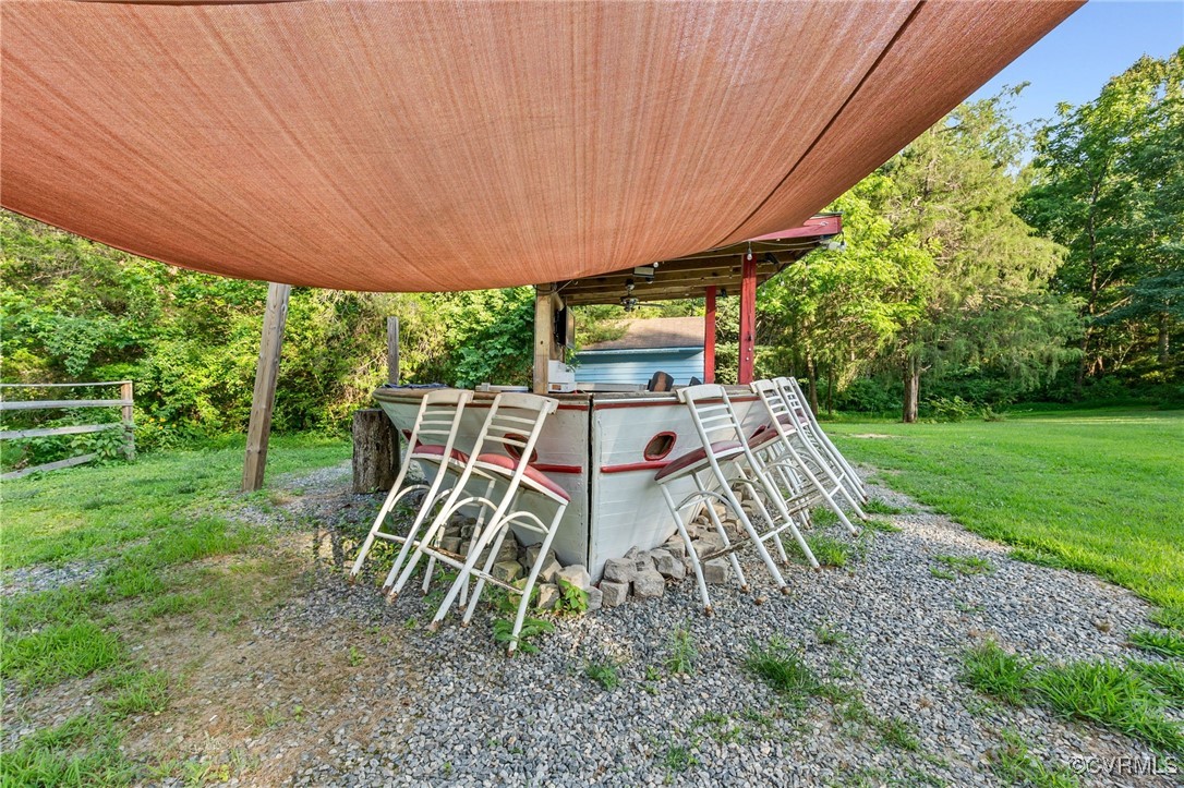 11925 Belfonte Road Bumpass, VA 23024 - Photo 30 of 34 a view of a patio with table and chairs under an umbrella