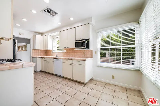 a kitchen with a stove a sink and a refrigerator