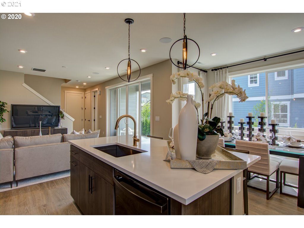 8229 Southeast Kinnaman Road Hillsboro, OR 97123 - Photo 3 of 21 a kitchen with a table chairs and a chandelier