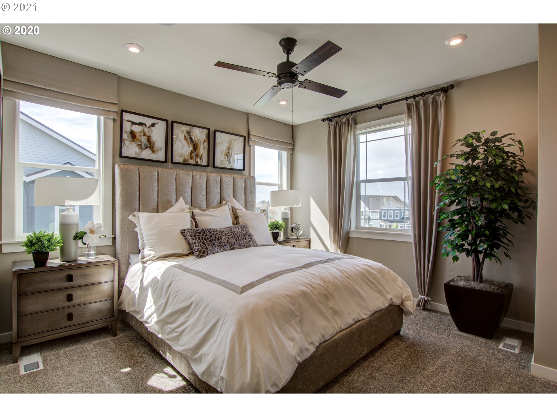 8229 Southeast Kinnaman Road Hillsboro, OR 97123 - Photo 7 of 21 a bedroom with a large bed and a potted plant