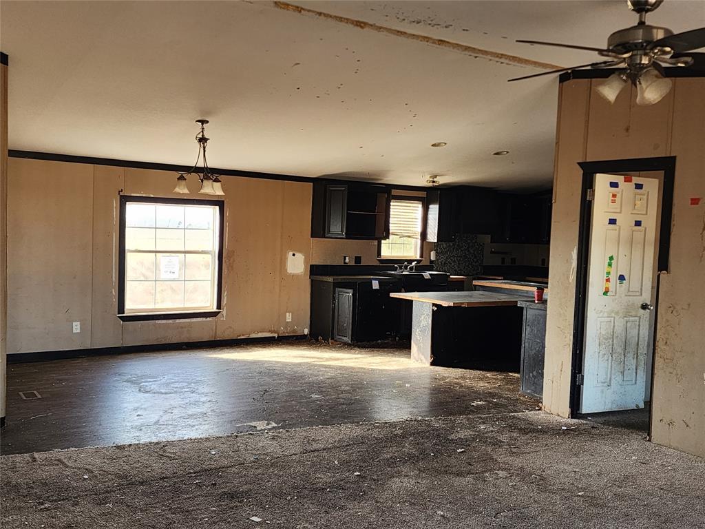 10279 Private Road 6055 Hawley, TX 79525 - Photo 5 of 9 a kitchen with stainless steel appliances granite countertop a stove a sink and a refrigerator