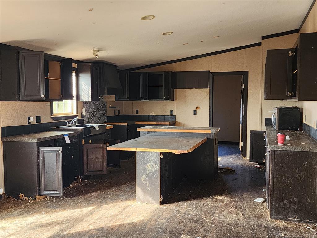 10279 Private Road 6055 Hawley, TX 79525 - Photo 7 of 9 a kitchen with stainless steel appliances granite countertop a sink stove and refrigerator
