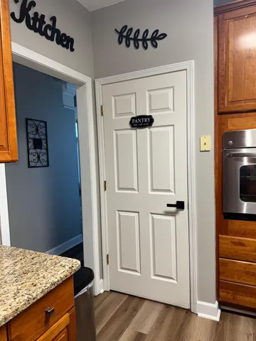 a living room with furniture and a view of kitchen