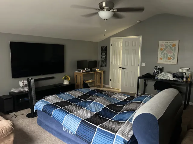a view of walk in closet with clothes