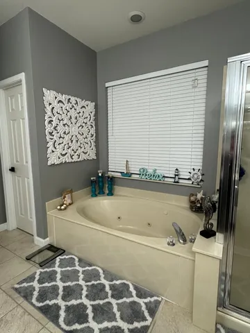 a living room with furniture and a ceiling fan