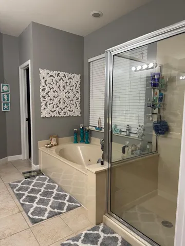 a living room with furniture and a dining table with kitchen view