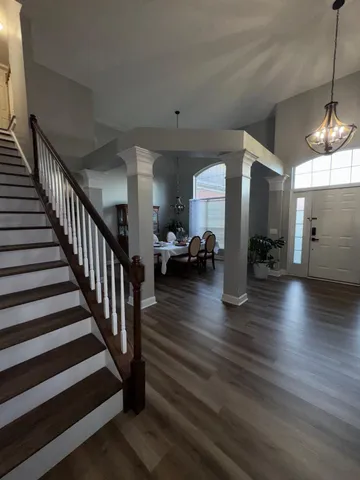 a living room with furniture and wooden floor