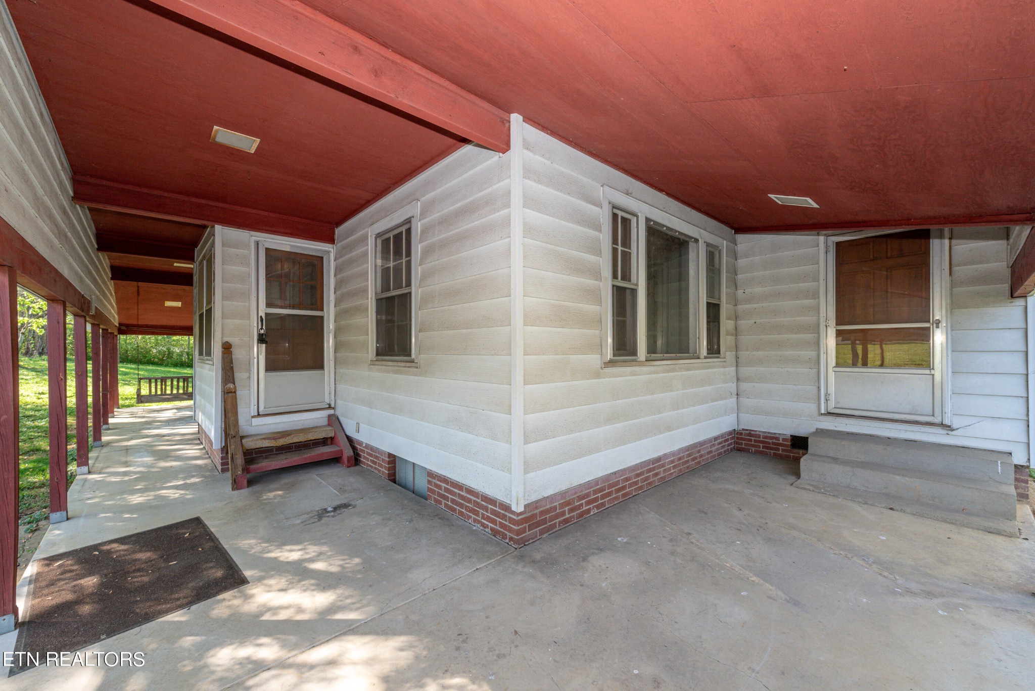 115 Wears Valley Road Townsend, TN 37882 - Photo 13 of 49 a view of a porch with a table and chairs