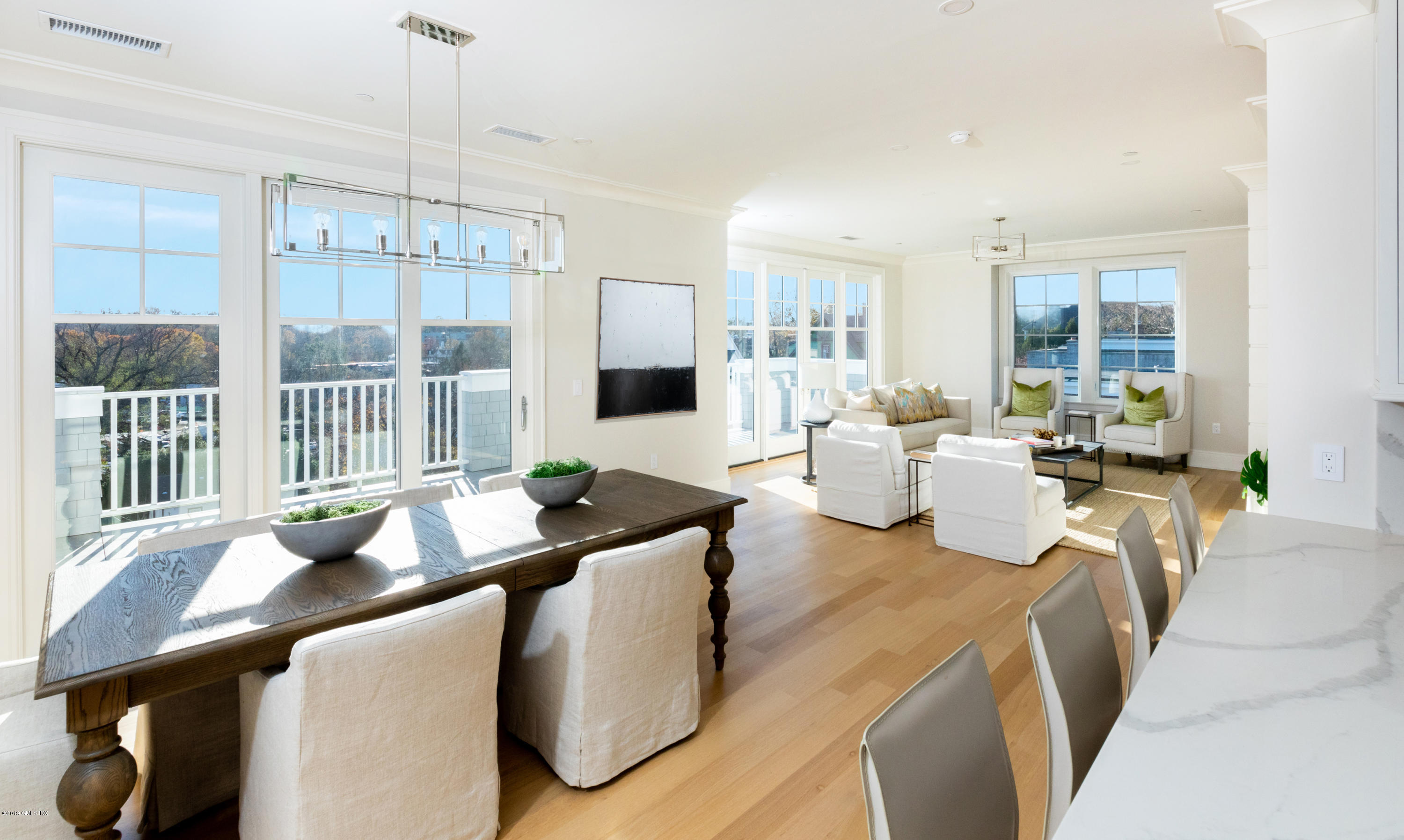 70 Sound View Drive, Unit PH WEST Greenwich, CT 06830 - Photo 2 of 16 a living room with furniture fireplace and large windows
