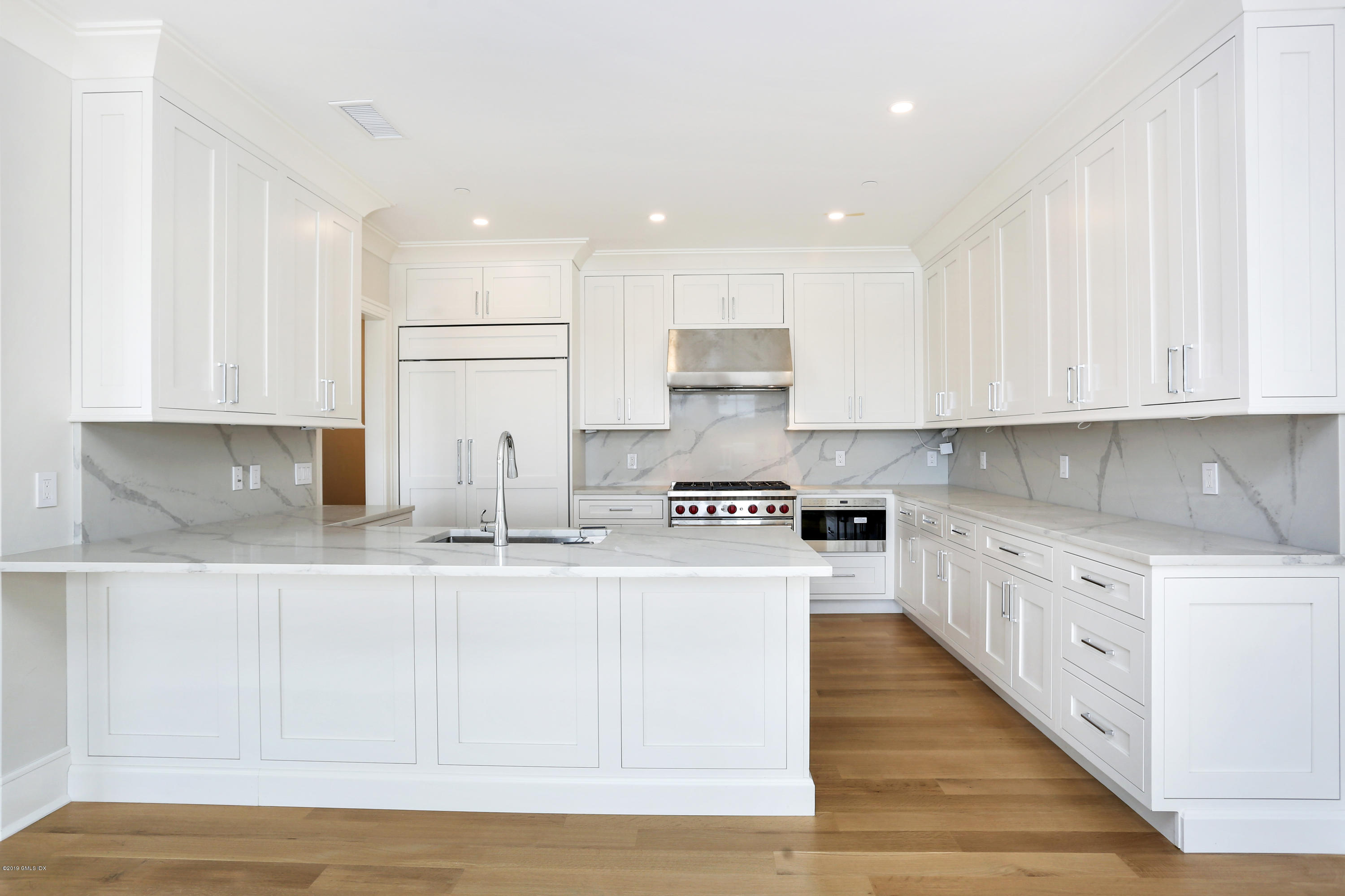 70 Sound View Drive, Unit PH WEST Greenwich, CT 06830 - Photo 6 of 16 a large kitchen with stainless steel appliances granite countertop a stove a sink a refrigerator and white cabinets