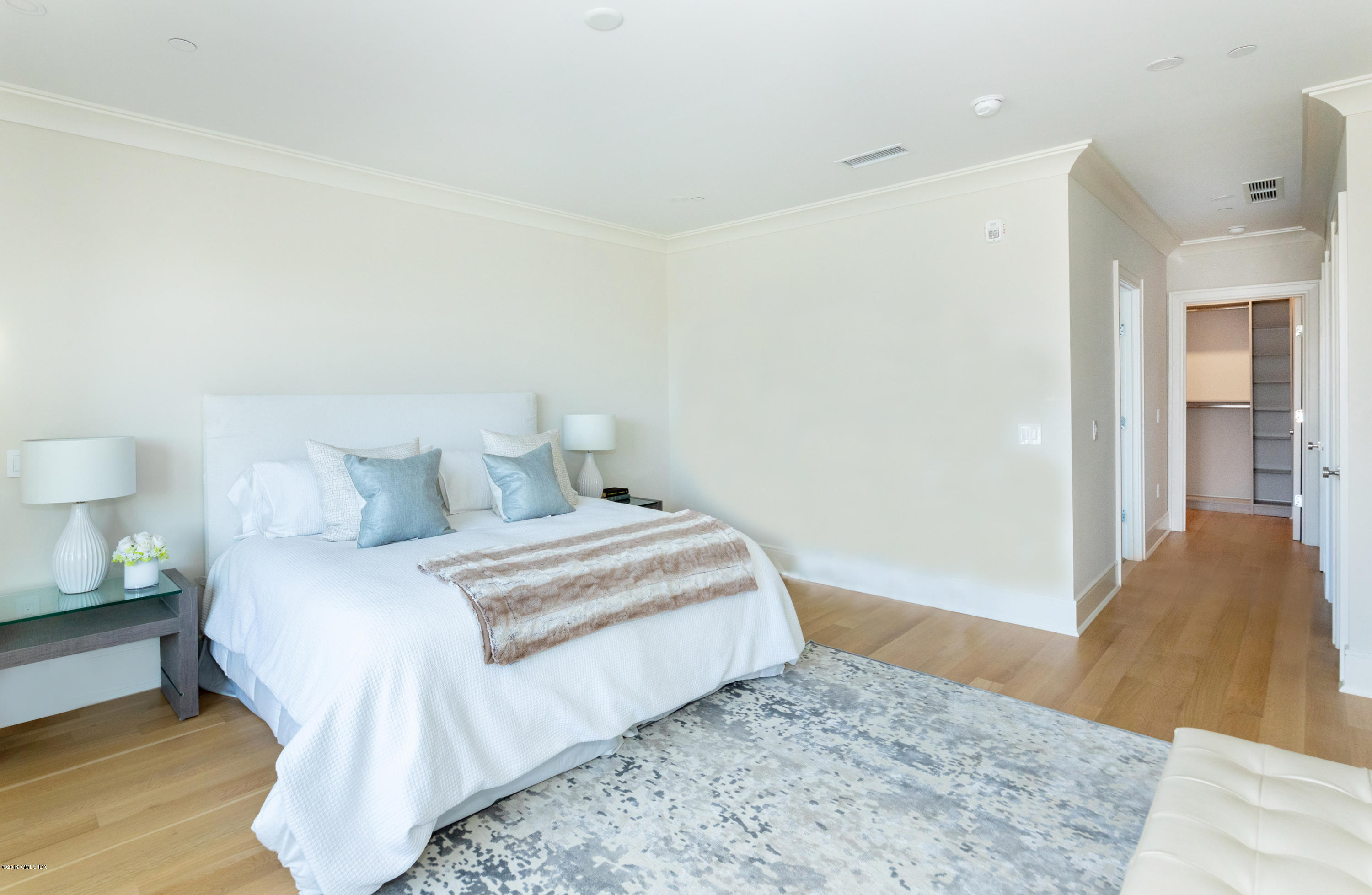 70 Sound View Drive, Unit PH WEST Greenwich, CT 06830 - Photo 7 of 16 a bedroom with a bed and wooden floor