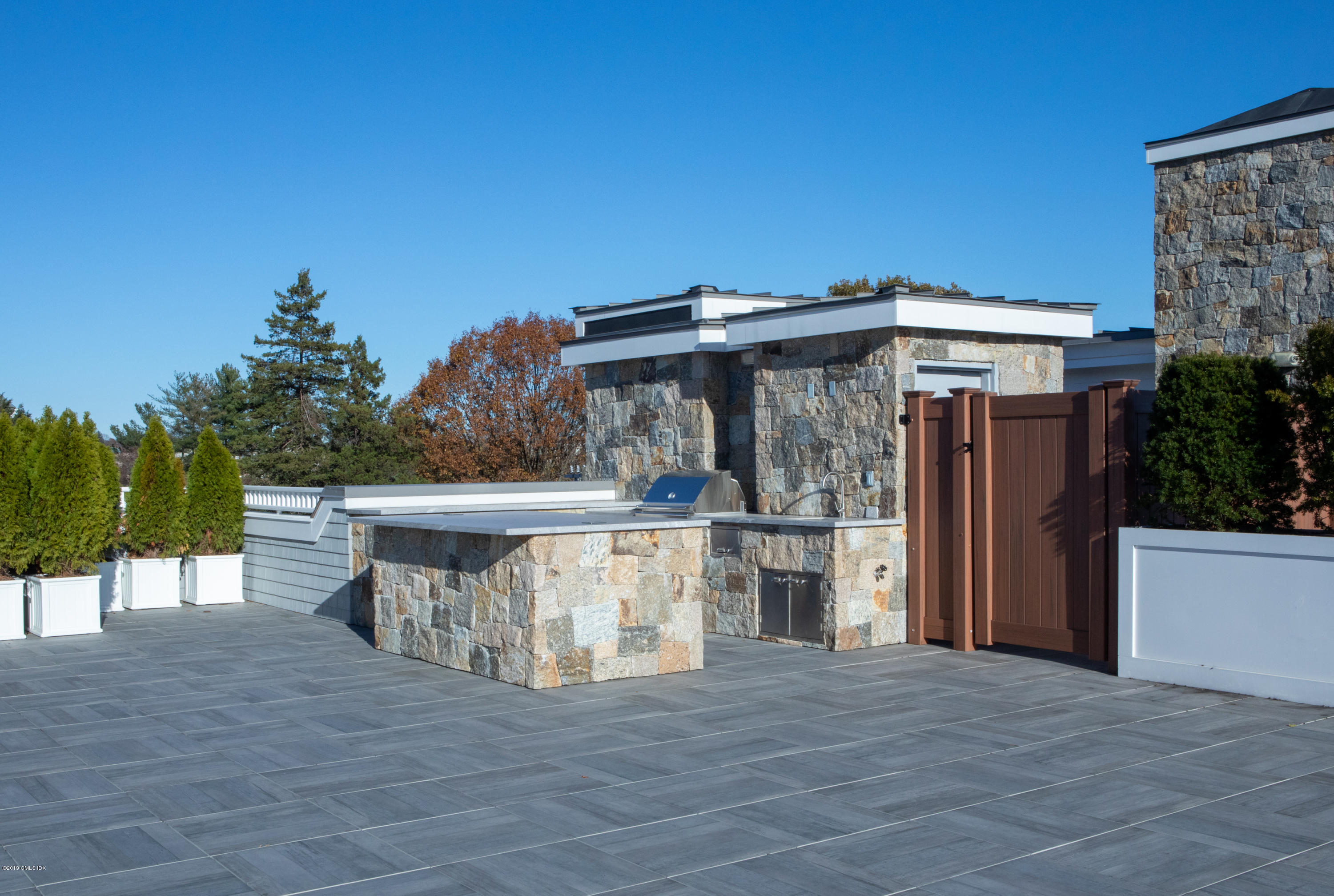 70 Sound View Drive, Unit PH WEST Greenwich, CT 06830 - Photo 10 of 16 a view of a house with a wooden deck