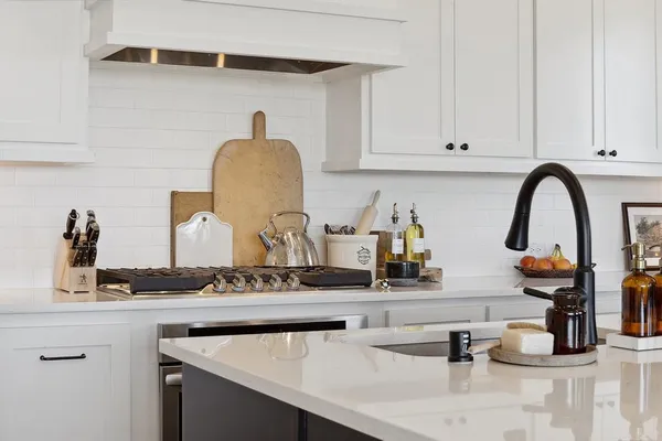 a kitchen with sink and a white cabinets