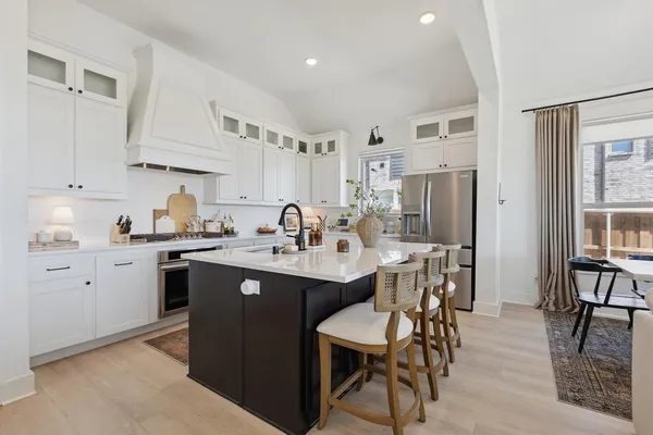a kitchen with stainless steel appliances kitchen island granite countertop a sink and cabinets