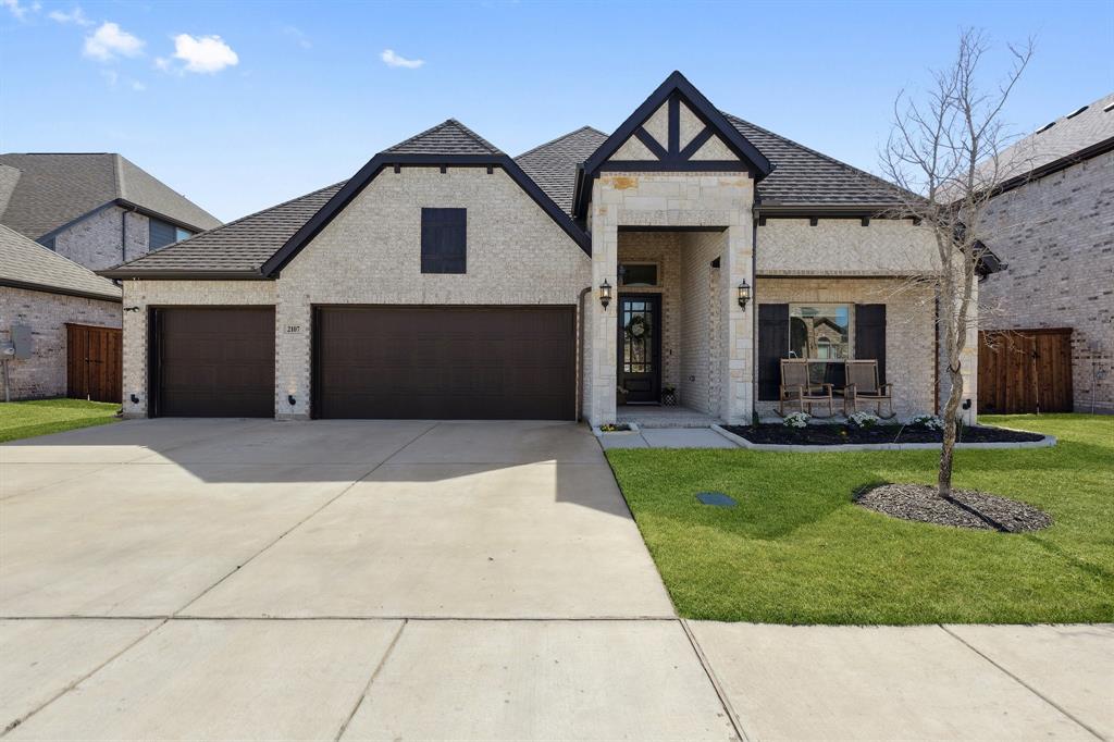 2107 Ozarks Court Forney, TX 75126 - Photo 2 of 40 a front view of a house with a yard and garage