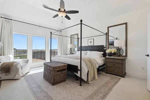 a bedroom with a bed window and couch