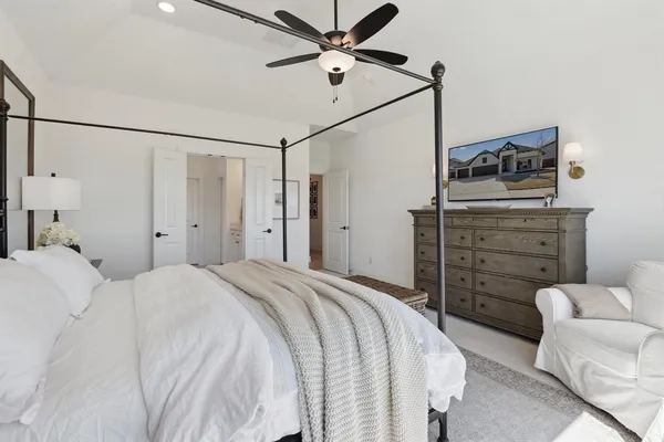 a bedroom with a bed and a ceiling fan
