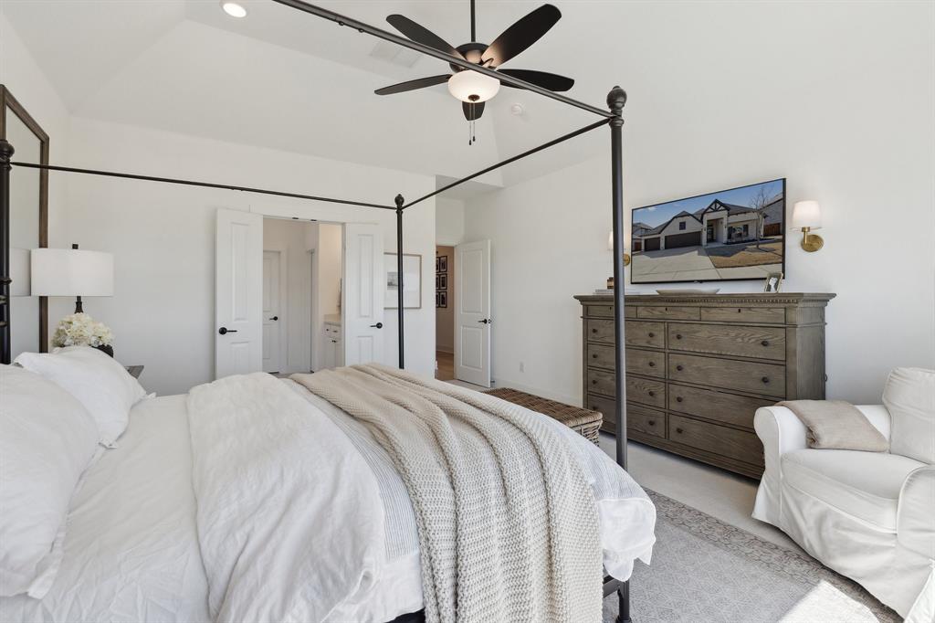 2107 Ozarks Court Forney, TX 75126 - Photo 22 of 40 a bedroom with a bed and a ceiling fan