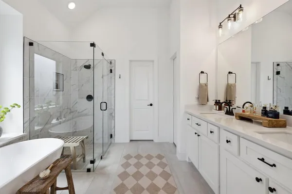 a bathroom with a double vanity sink mirror double shower and a bathtub