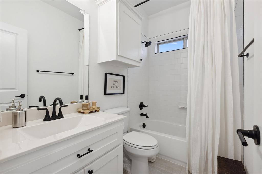 2107 Ozarks Court Forney, TX 75126 - Photo 28 of 40 a bathroom with a sink a toilet and shower
