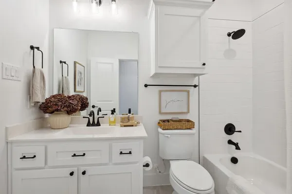 a bathroom with a sink a toilet and shower curtain