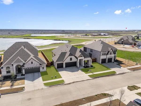 an aerial view of a house with a swimming pool and outdoor seating