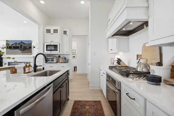 a kitchen with stainless steel appliances granite countertop a sink and cabinets