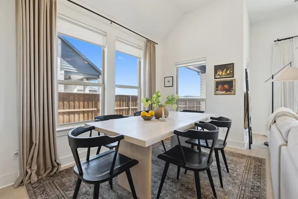 a view of a dining room with furniture and window