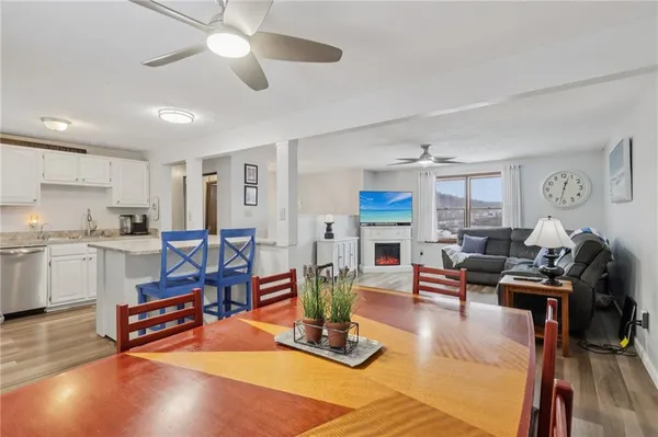 a living room with furniture pool table and chairs
