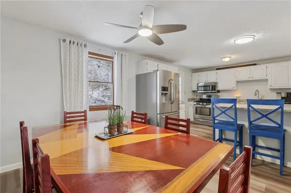 a dining room with furniture and window