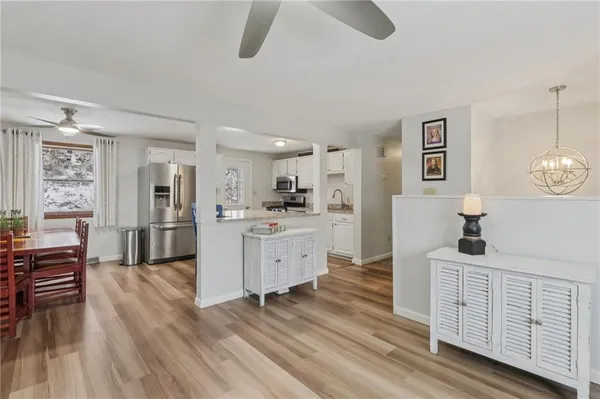 a kitchen with white cabinets and sink