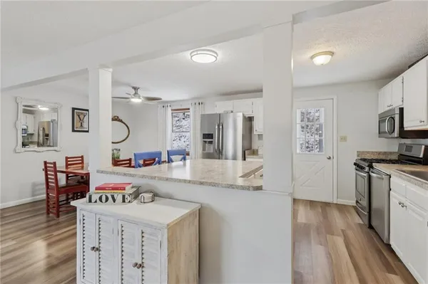 a room with furniture a wooden floor and a sink