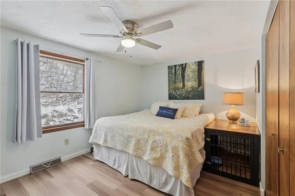 a bedroom with a large bed and a window