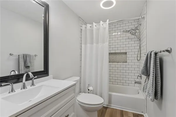 a bathroom with a sink a toilet and mirror