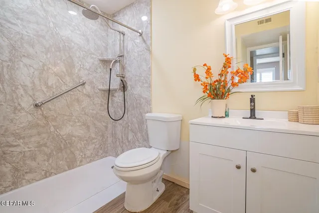 a bathroom with a toilet sink and shower