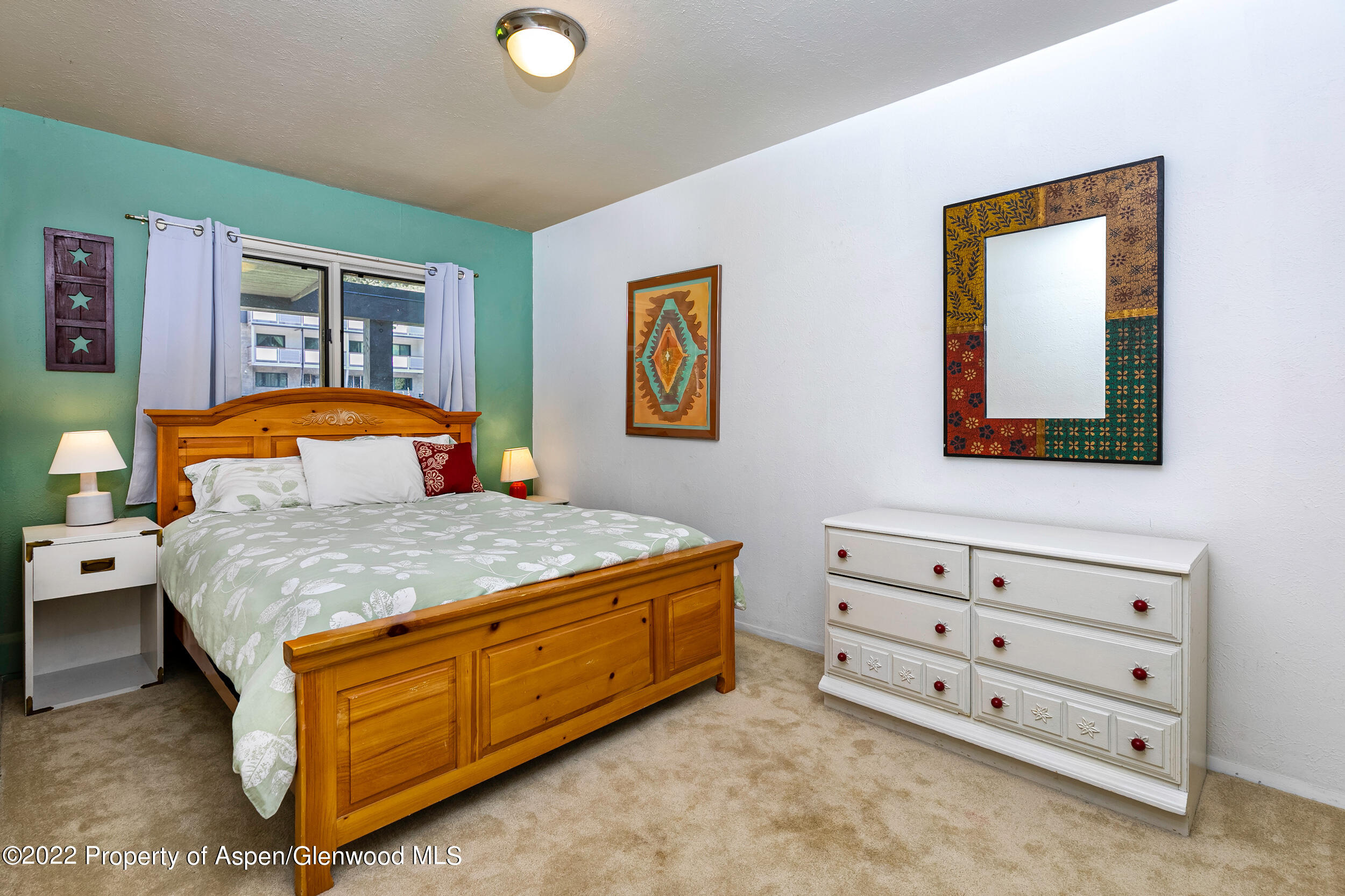 124 East Durant Avenue, Unit 4 Aspen, CO 81611 - Photo 4 of 13 a bedroom with a bed and a dresser